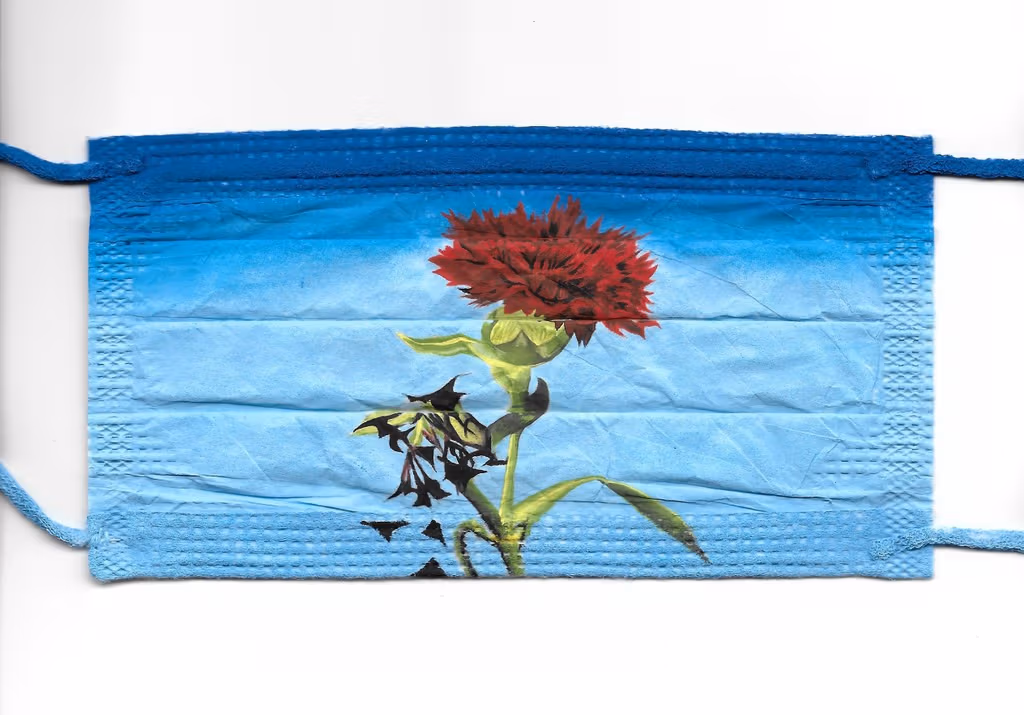 Painting of a red carnation on a surgical mask.