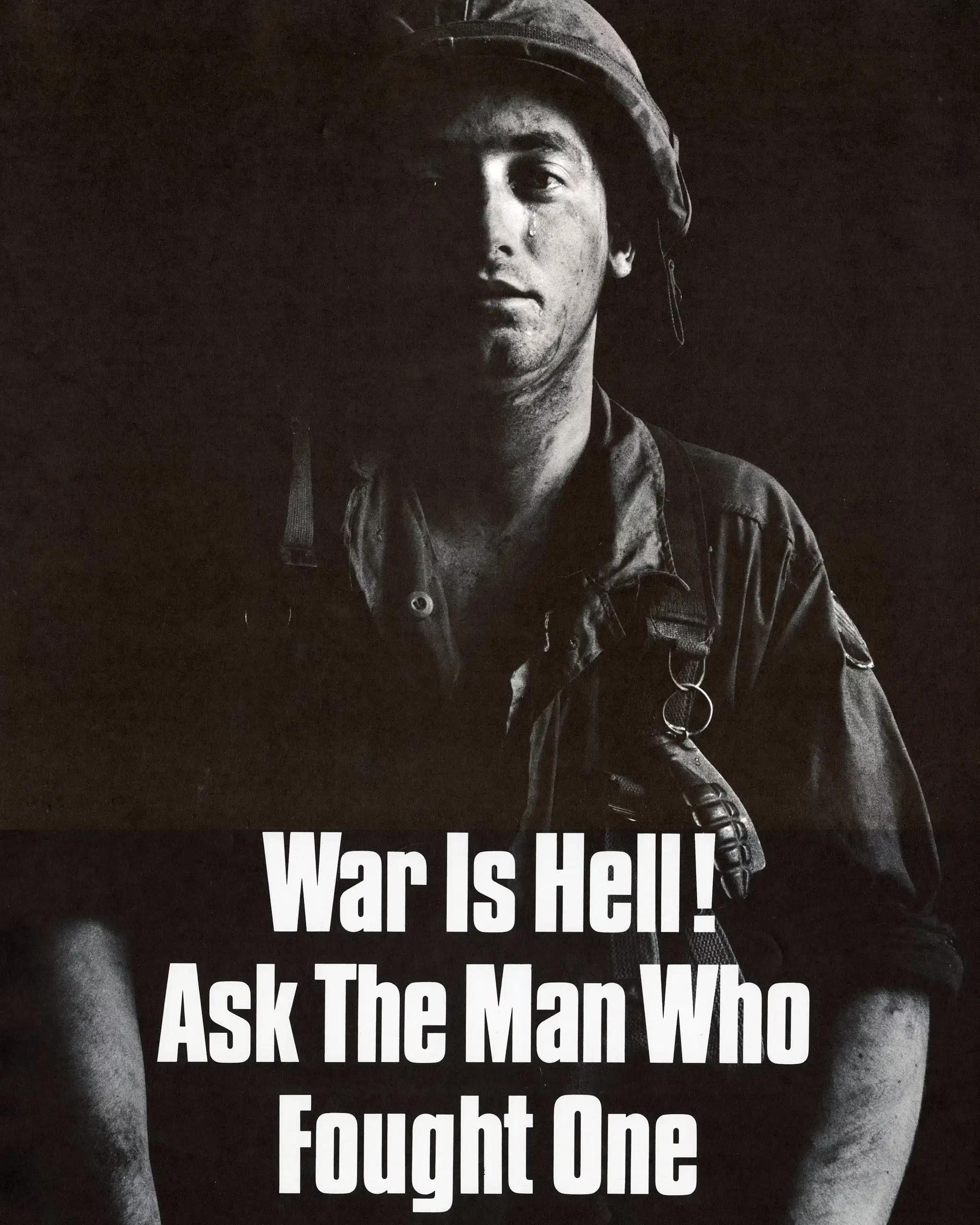 A poster against the Vietnam War, depicting a black and white picture of a soldier with a tear streaming down his face. The words "War is Hell! Ask the man who fought one" are written in bold white letters. 