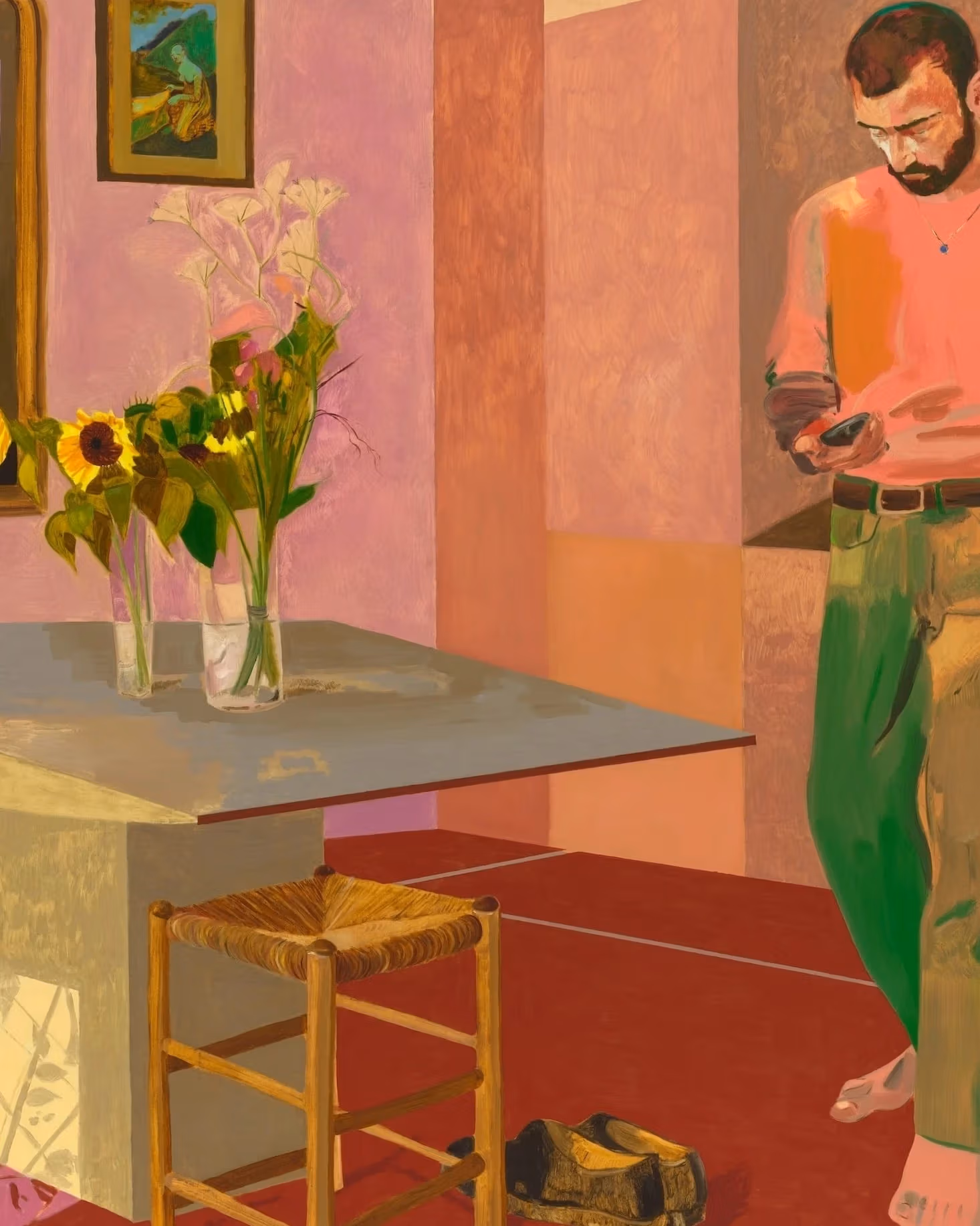 A painting by Anthony Cudahy depicting a man standing in a room. He is looking down at what appears to be a cell phone. A table is in front of him with two vases filled with with flowers. 