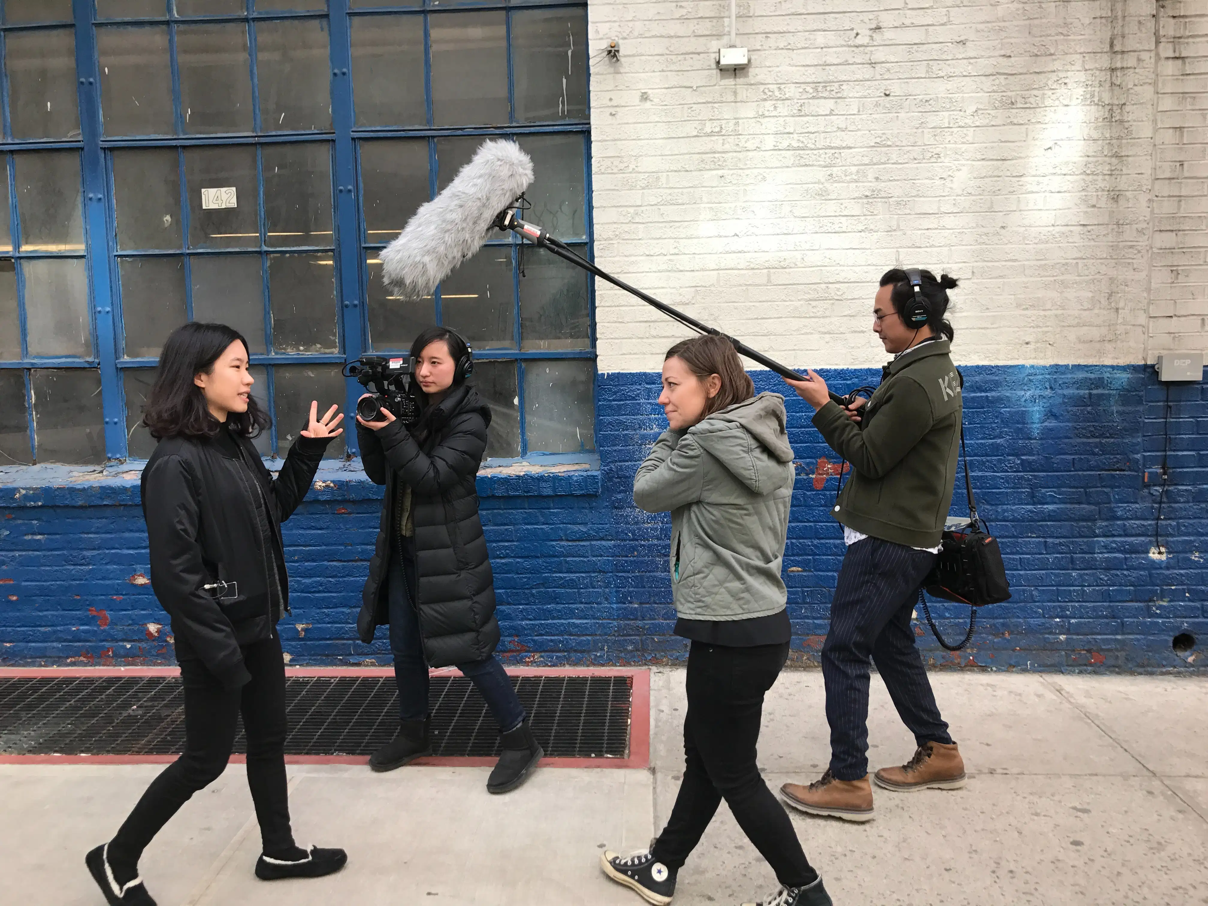 Student filmmakers in an outdoor location filming schoolwork.