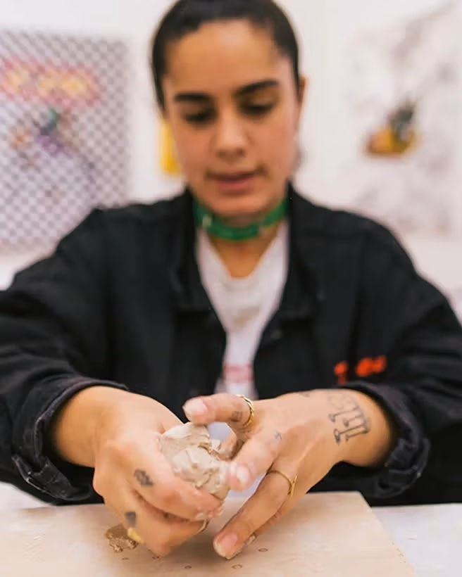 Women preparing clay for a sculpture