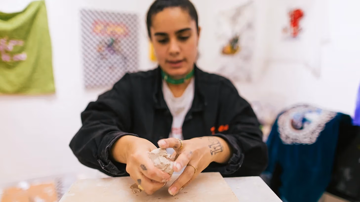 Women preparing clay for a sculpture