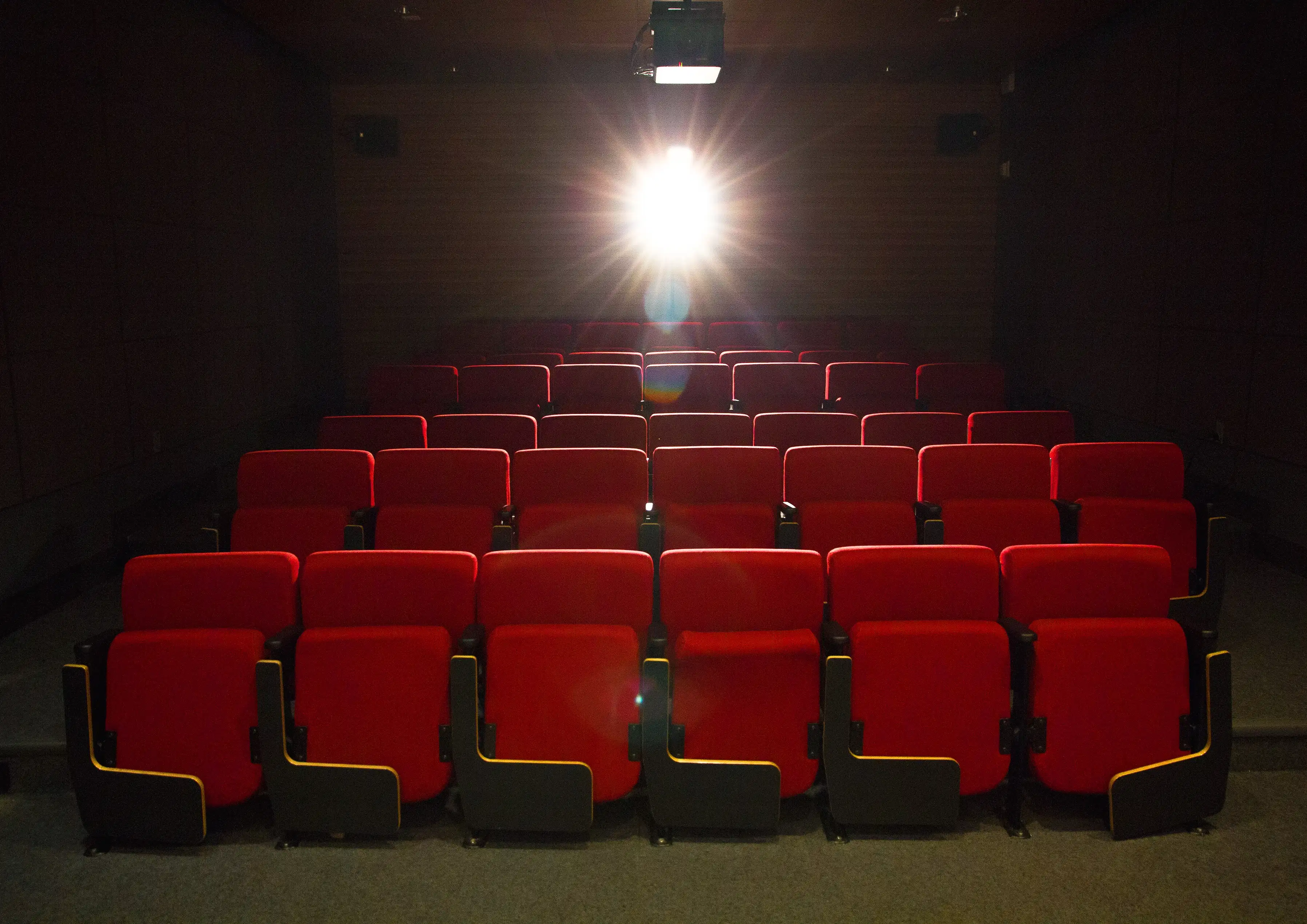 Empty theater with red seats.