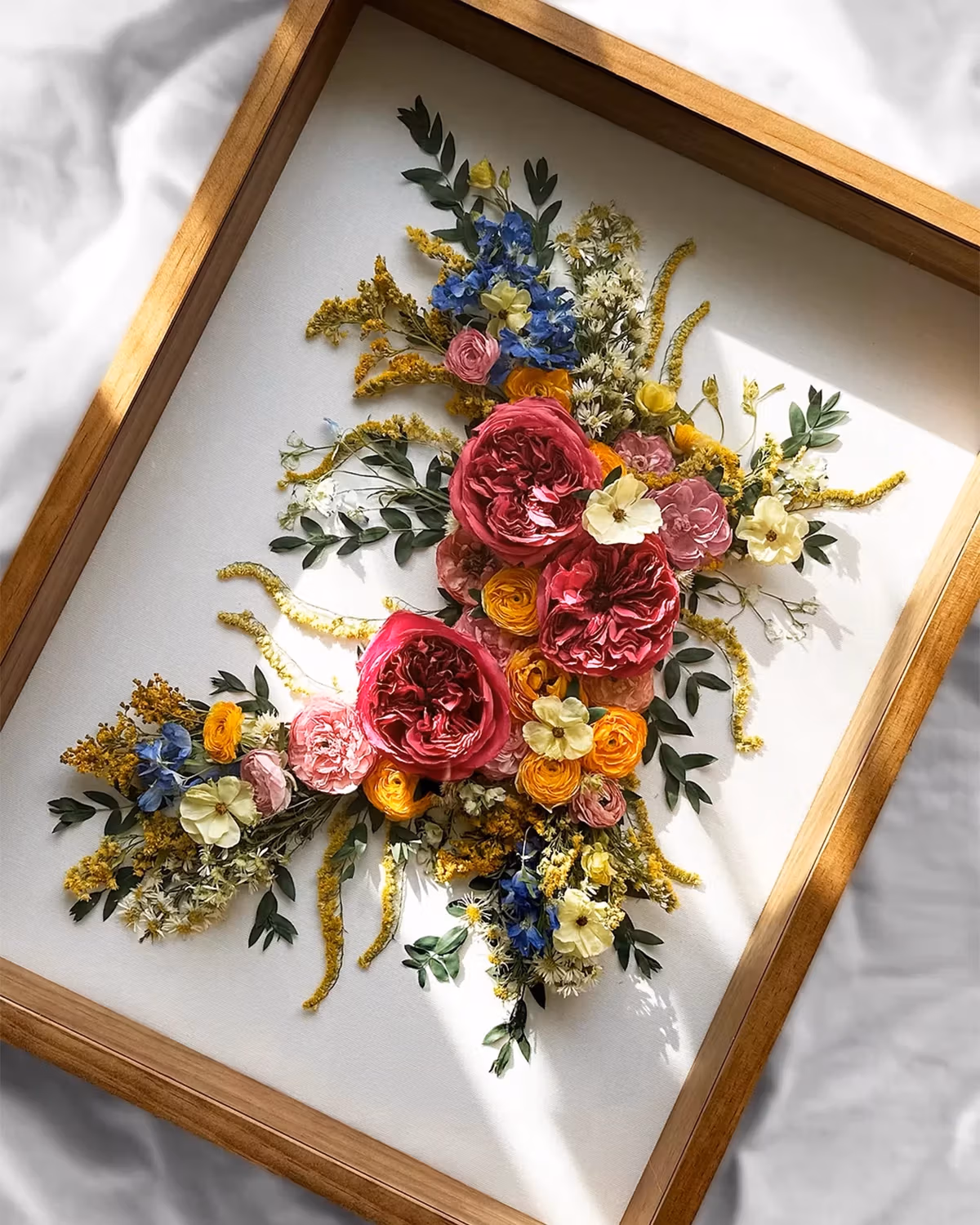 Preserved flowers placed in a wooden picture frame