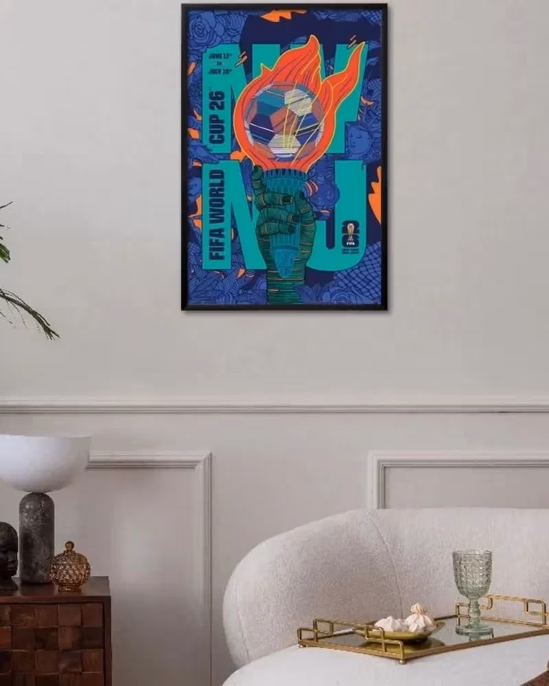 Rich Tu's FIFA 2026 New York New Jersey poster hung up in a frame on the wall of a room.