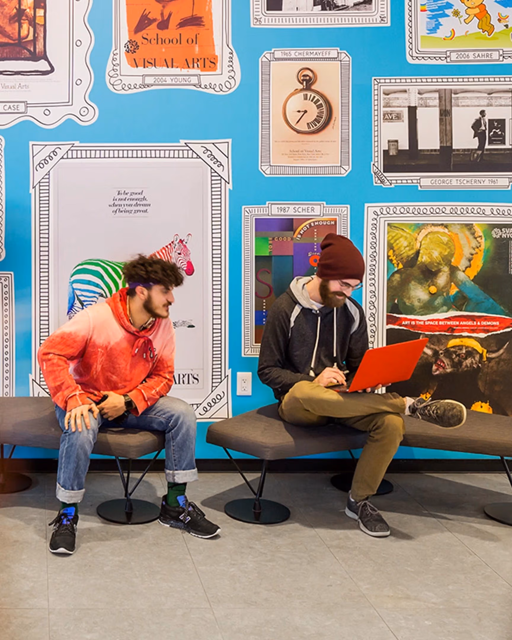 Students sitting in front of the poster wall in the 24th Street Residence.