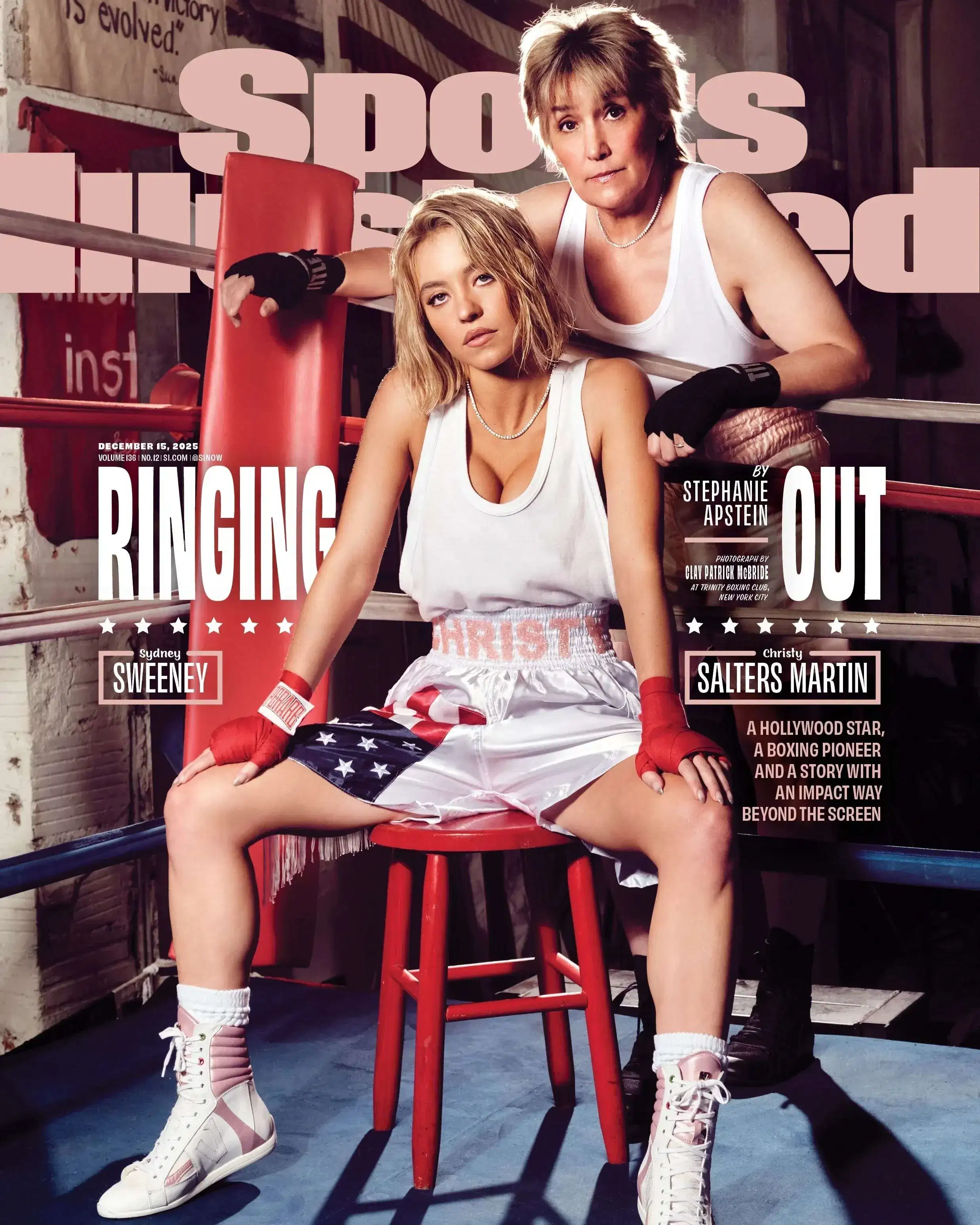 Two people in a boxing ring, both wearing white tank tops. One sits on a red stool, looking confident; the other leans on the ropes, conveying strength.