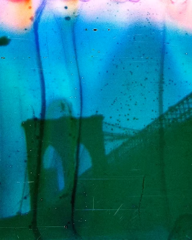 Abstract image of a bridge with an arch and cables, layered in vivid green, blue, and orange tones. The mood is surreal and dreamlike.