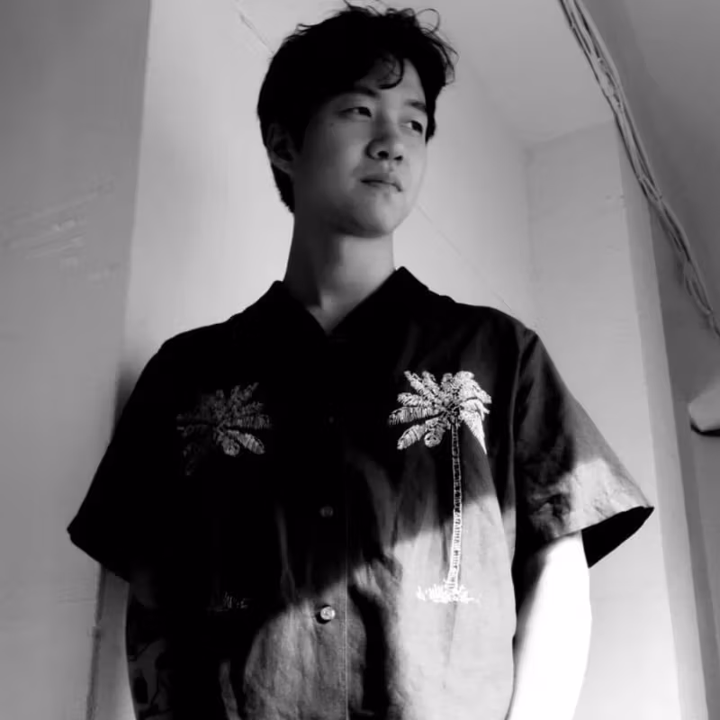 A black and white image of a young person looking off to the side.