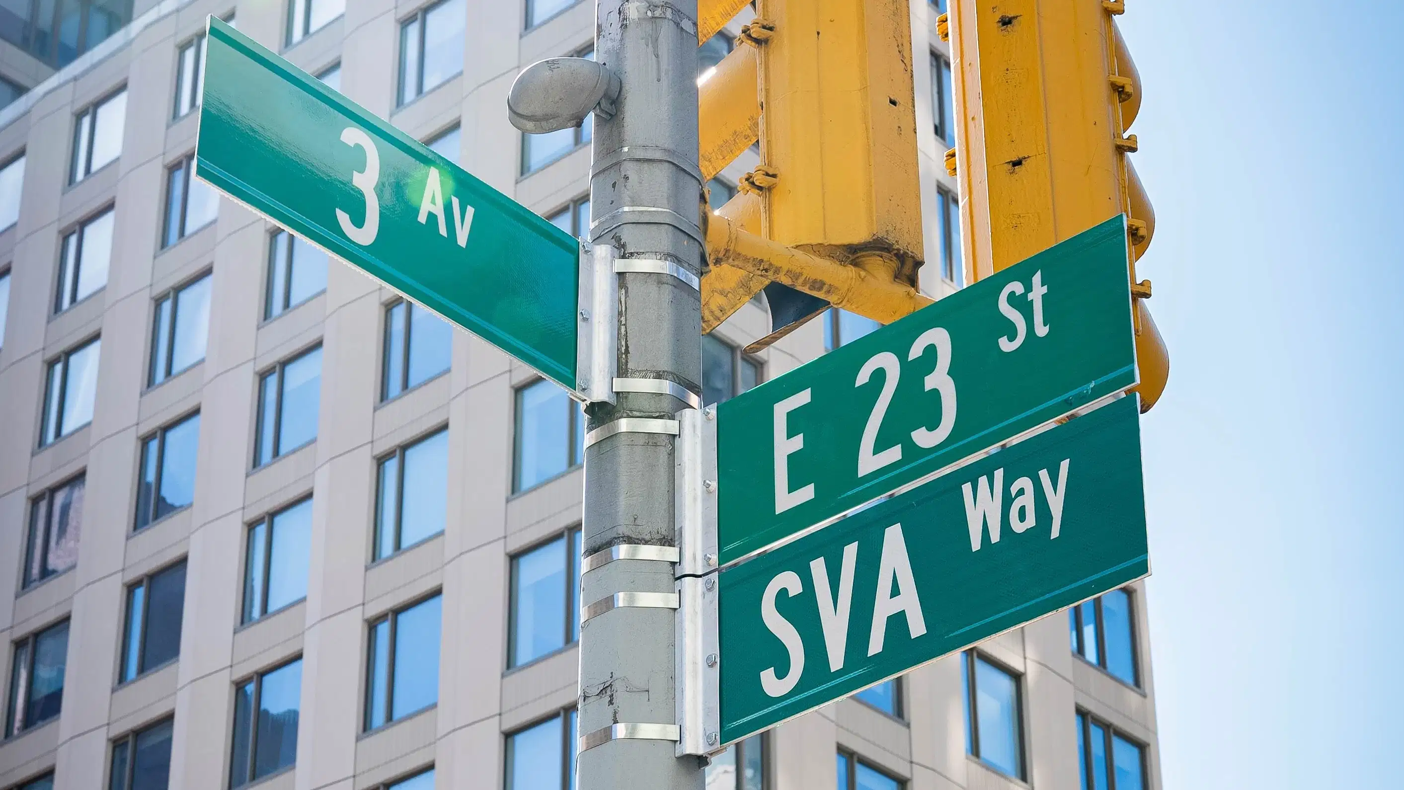Street sign showing the corner of 3rd Avenue and 23rd Street; under the 23rd street sign is a duplicate sign that reads "SVA Way"