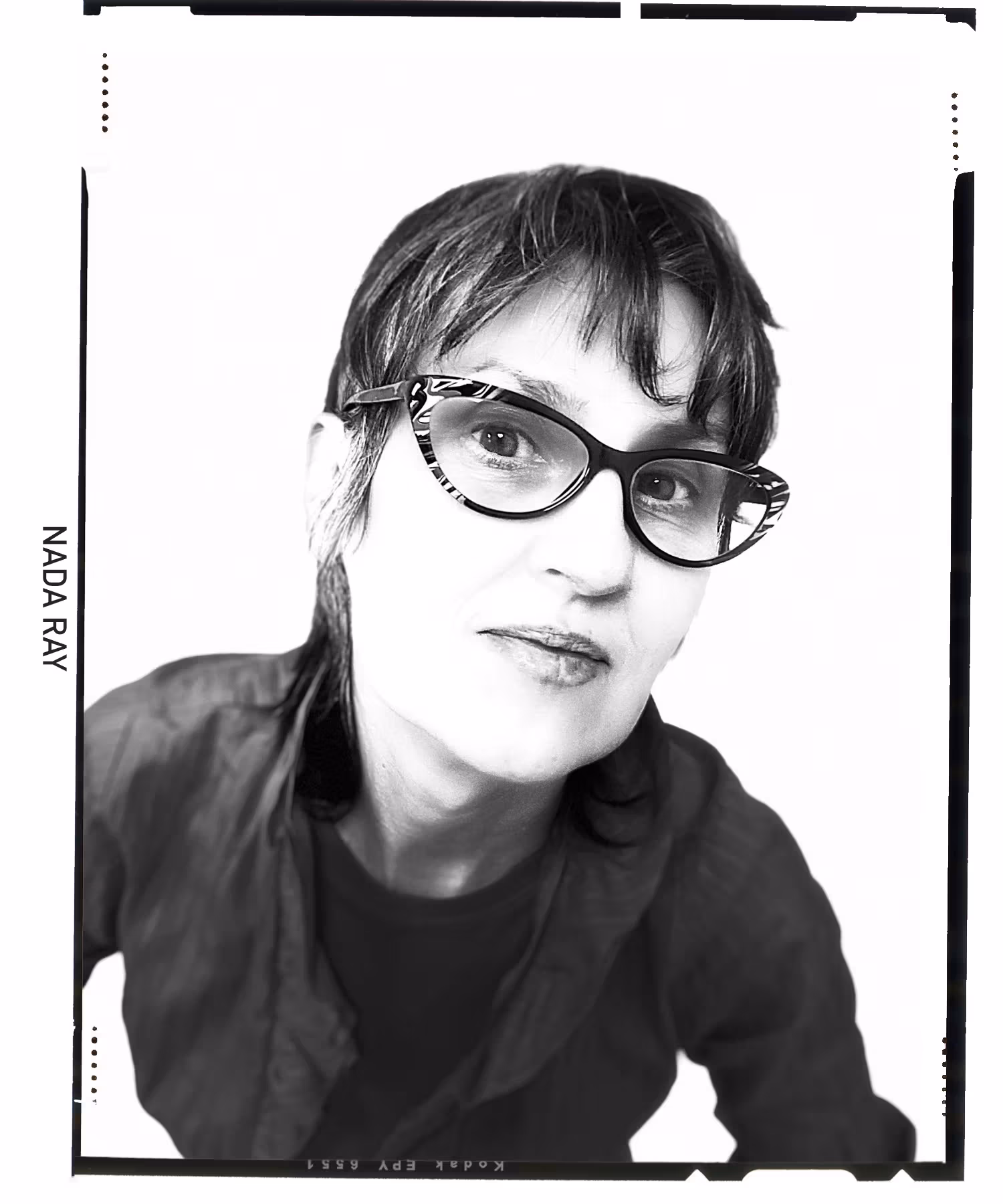 Black and white photo of woman with glasses. 