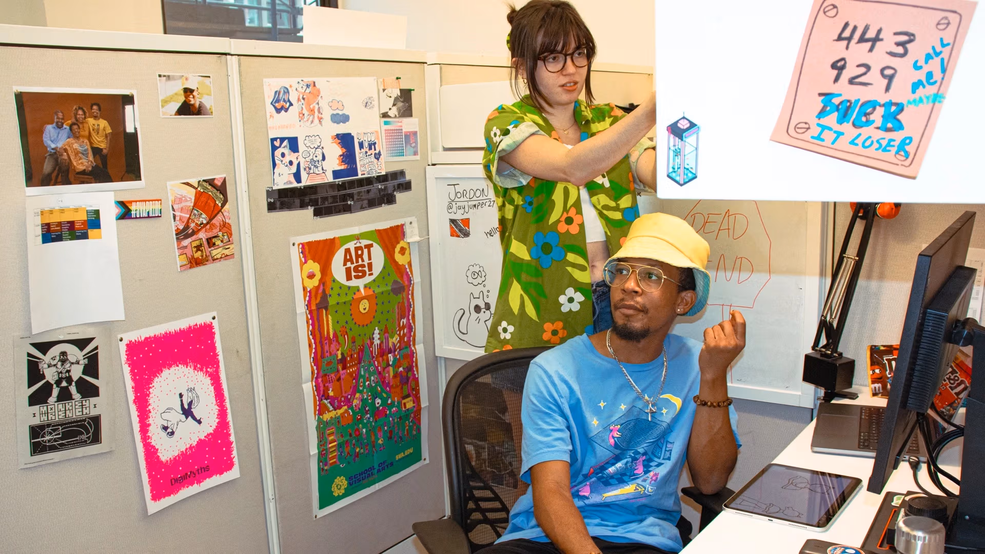 Two students in their studio workspaces.