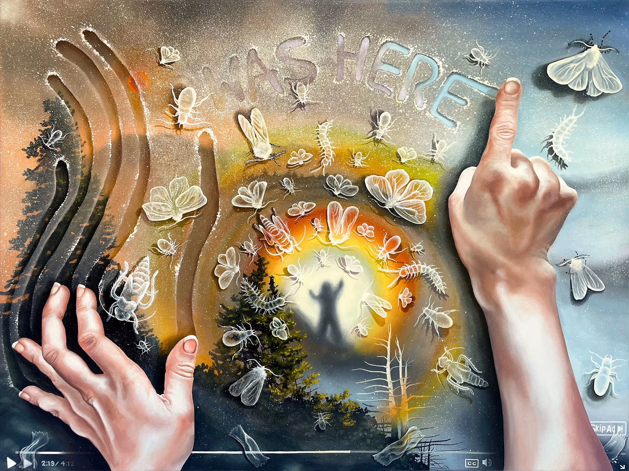 Two hands rest atop a surface, the left drawing vertical lines with their fingers, the right pointing creating the words "I Was Here" out of a sandy texture. Below this semi-transparent texture is a forested landscape with a figure standing atop a mountain as a rainbow radiates around them.
