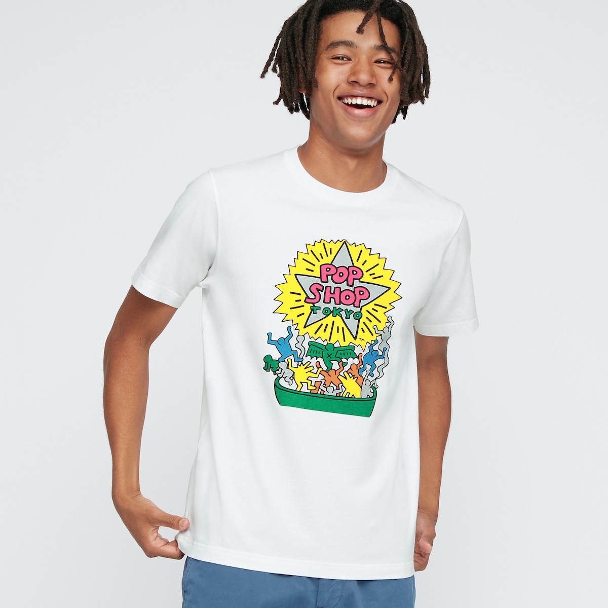 A photograph of a person wearing a T-shirt bearing an illustration by Keith Haring.