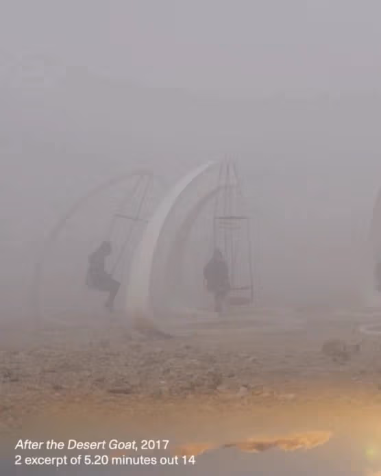 An image of a very foggy landscape where people sit on white structures with hanging seats.
