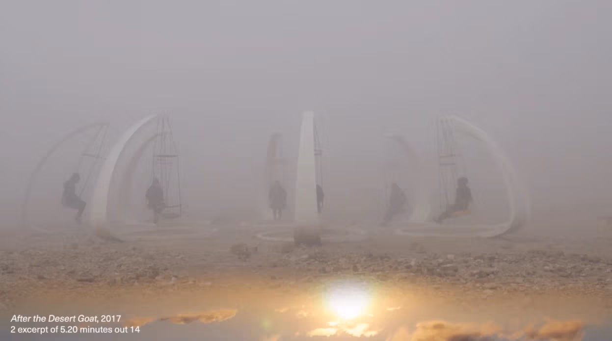 An image of a very foggy landscape where people sit on white structures with hanging seats.