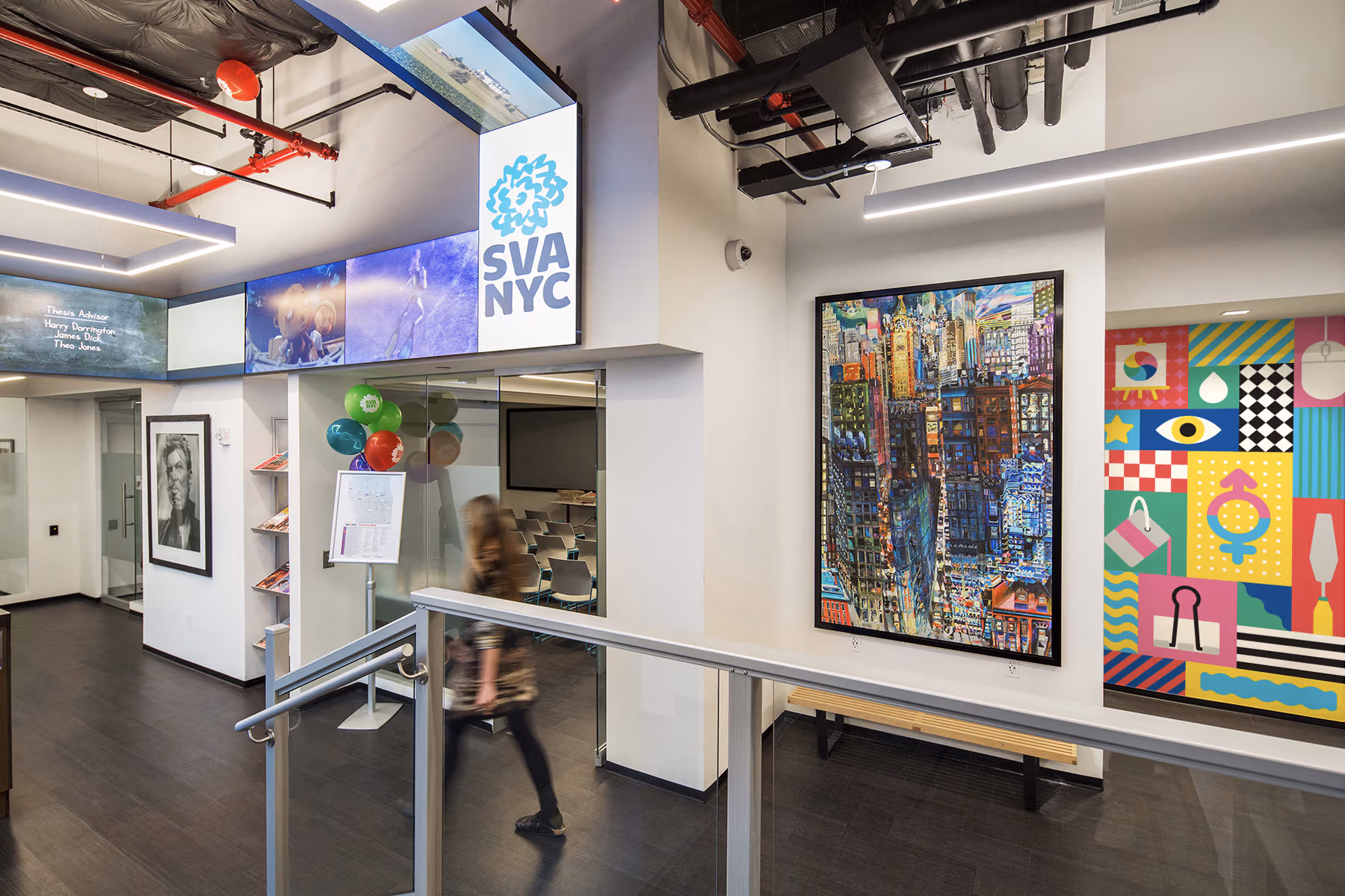 Entry of SVA Welcome Center, brightly colored artwork lines the walls.