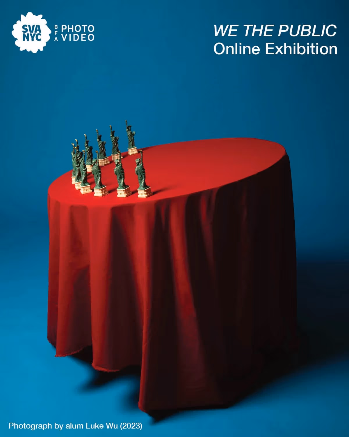 A red table leaning to the left with small statue of liberty replicas on top